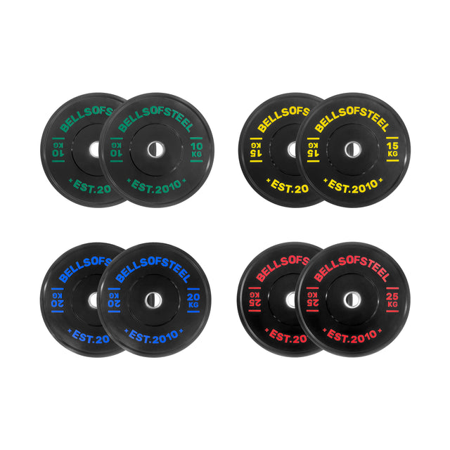 The Dead Bounce Conflict Bumper Plate Sets by Bells of Steel include four pairs of black plates (10 kg green, 15 kg yellow, 20 kg blue, 25 kg red) labeled with “BELLS OF STEEL EST. 2010” and made from virgin rubber for a dead bounce.