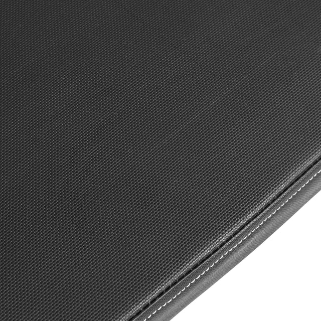 Close-up of a dark grey fabric surface resembling the Bells of Steel Flat/Incline/Decline Weight Bench, showcasing textured upholstery with a seam and visible stitching.