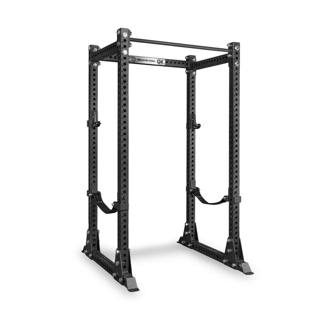 The Bells of Steel Manticore Flat Foot Power Rack Builder (3" x 3", 1" Holes) is a black metal power rack for weightlifting, featuring adjustable supports, multiple attachment points, and a pull-up bar at the top—an ideal sturdy home gym solution shown against a white background.