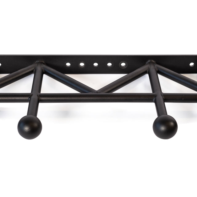 The Bells of Steel Globe Pull Up Bar is a black metal wall-mounted bar with a geometric truss design, durable steel build, and evenly spaced holes along the top bar for mounting.