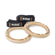 Bells of Steel Gymnastics Rings with black adjustable straps and orange details are perfect for bodyweight training, displayed on a white background. Ideal for enhancing your core workout routine.