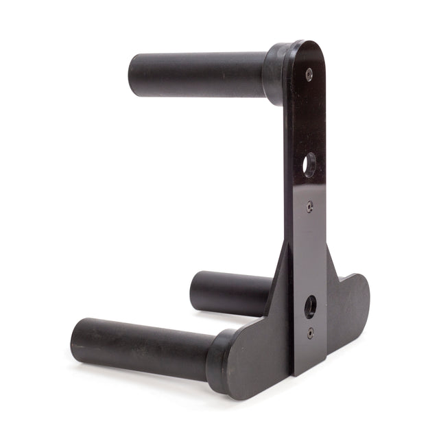 The Bells of Steel Change Plate Storage Pegs are black metal wall-mount brackets with padded horizontal arms and vertical support, securely holding gear against the wall. Features screw holes for easy installation.