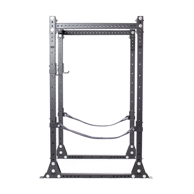 The Bells of Steel Hydra Flat Foot Power Rack Builder (3" x 3", ⅝" Holes) is a black metal rack with adjustable J-hooks, safety straps, and pull-up bar, ideal for home gym weightlifting and strength training.