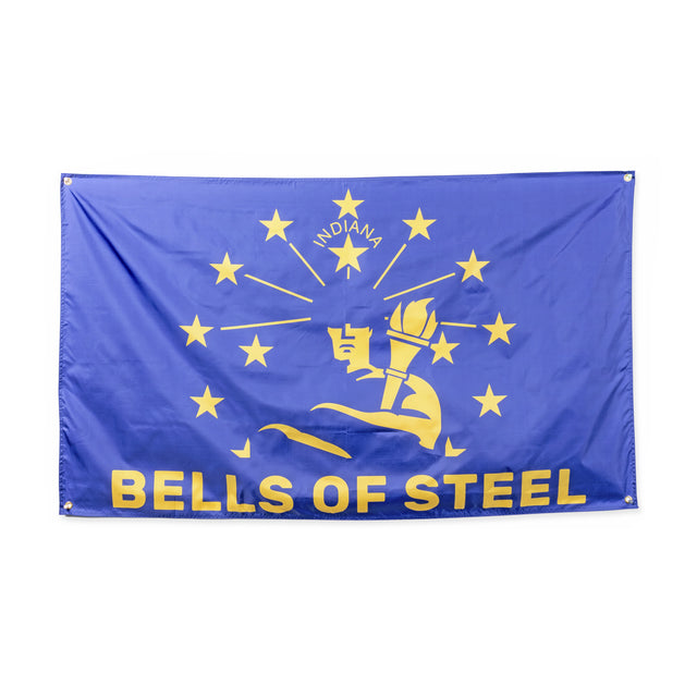 A blue Bells of Steel Flags gym flag with yellow torch and stars design, “INDIANA” at the top, and bold “BELLS OF STEEL” at the bottom—ideal decor for your home gym.