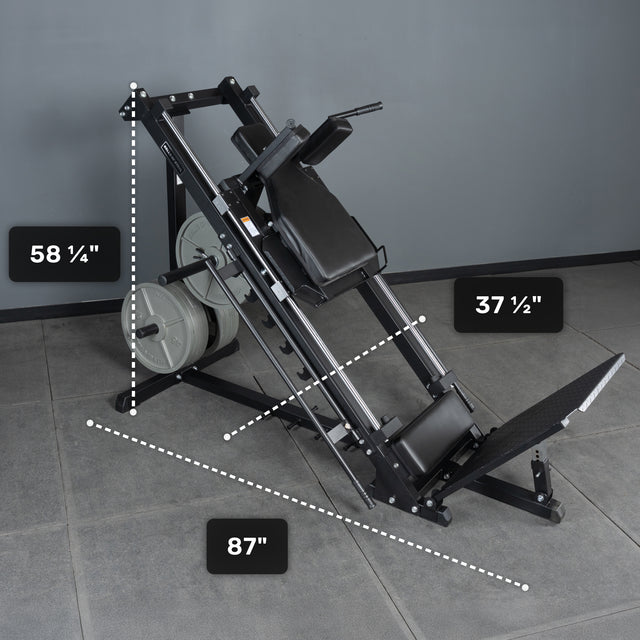 A black Bells of Steel Leg Press Hack Squat Machine sits on a gray tiled floor, ideal for home gyms. White dotted lines and labels show its size: 58¼" tall, 87" long, and 37½" wide, with weight plates loaded on one side.