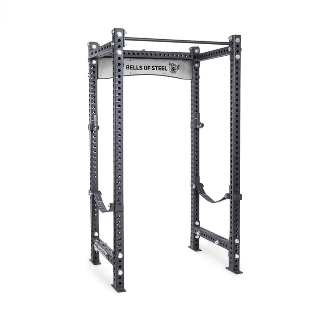 The Manticore Four Post Power Rack - Prebuilt by Bells of Steel features 3"x3" posts with 1" holes, a pull-up bar, safety straps, and a branded logo plate—ideal for any home gym.