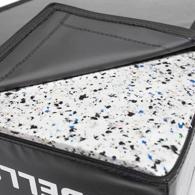 Close-up of Bells of Steel Deadlift Pads (Pair) showing the black vinyl cover partly open to reveal thick white foam padding with blue, black, and gray specks inside.