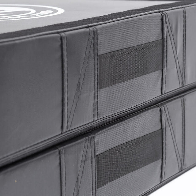 Close-up of Bells of Steel Deadlift Pads (Pair) stacked, featuring reinforced stitching and black hook-and-loop fastener strips along the edges.