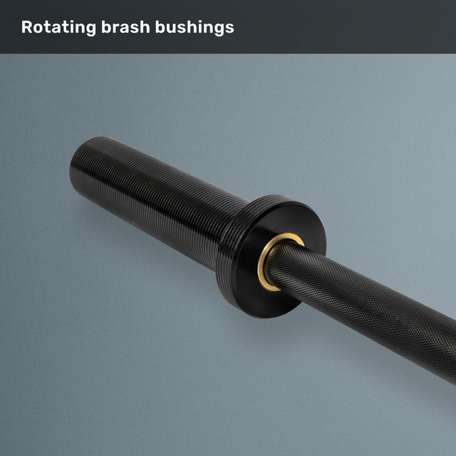 A close-up of the Bells of Steel Short Rackable Barbell sleeve with rotating brass bushings against a gray background. The text at the top reads "Rotating brass bushings." Perfect for your home gym setup.