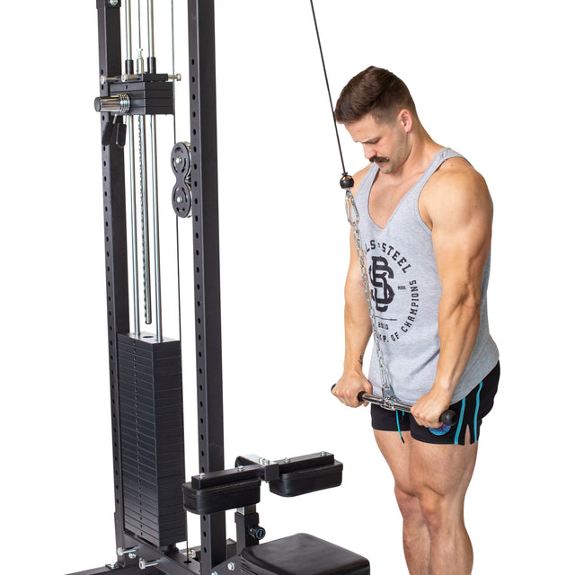 A man in a gray tank top and shorts performs a triceps pushdown on a cable machine using the Bells of Steel Straight Bar Cable Attachment (20"), gripping the bar with both hands while standing upright.