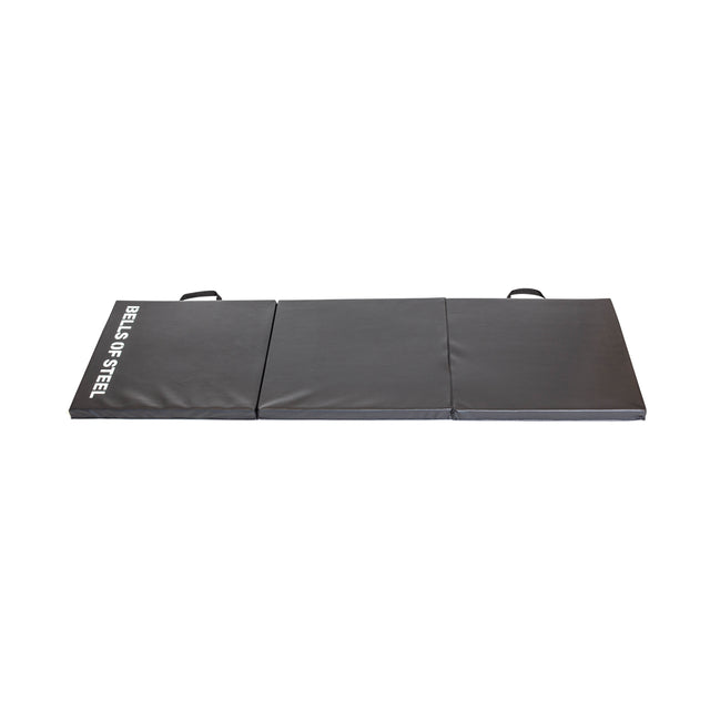 A gray, foldable exercise mat ideal for the Wildman Turkish Get Up Kettlebell Bundle by Bells of Steel. It’s sectioned into three parts, each with a handle for easy carrying and "Bells of Steel" text in white on the side, photographed on a pristine white background.