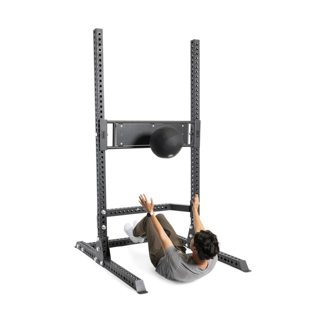 A person uses the Bells of Steel Utility Seat for Hydra/Manticore during fitness and strength training exercises.