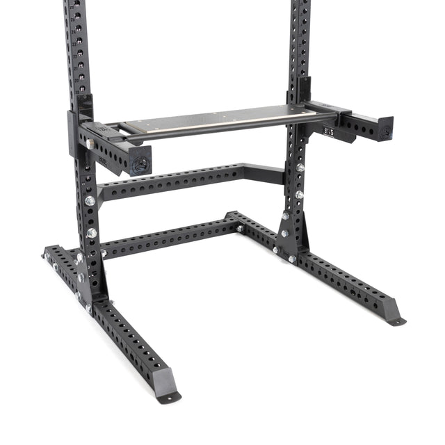 A close-up of the Bells of Steel Utility Seat for Hydra/Manticore, featuring black metal construction and multiple holes for height adjustment, designed to enhance weightlifting or strength training setups.