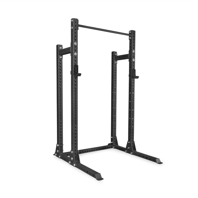 The Bells of Steel Hydra Half Rack Builder (3" x 3", ⅝" holes) is a black metal power rack with adjustable upright posts, a top pull-up bar, and safety catches—ideal for weightlifting in your home gym.