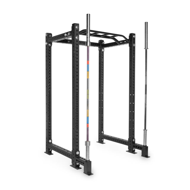 The Bells of Steel Front Foot Stabilizers power rack features a pull-up bar and built-in barbell storage, displaying two silver barbells (one with colored markings, one plain) at the front of the black rack against a white background.