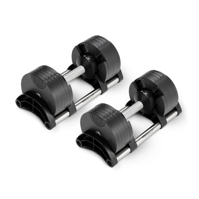 Two Nuobell NÜOBELL Adjustable Dumbbells with patent-pending design and machined steel weight plates are side by side on a white background, featuring sleek silver handles, modern lines, and multiple attached weights.