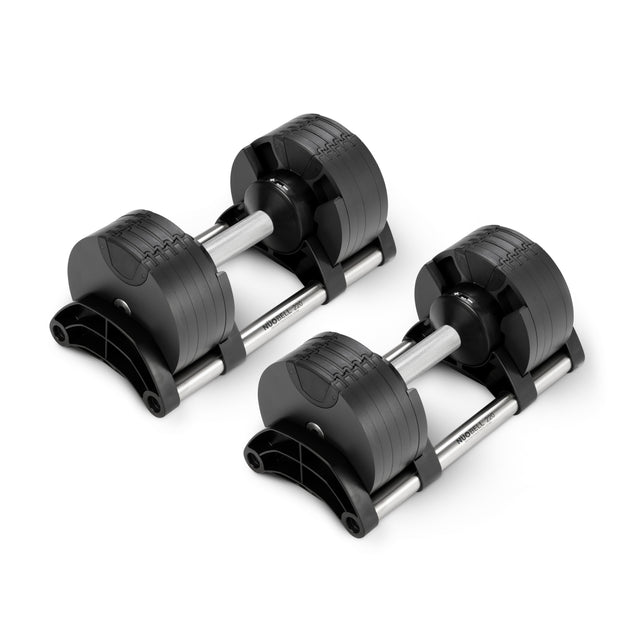 Two Nuobell NÜOBELL Adjustable Dumbbells with patent-pending design and machined steel weight plates are side by side on a white background, featuring sleek silver handles, modern lines, and multiple attached weights.