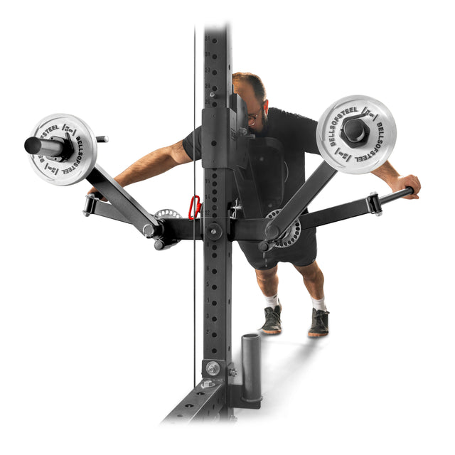 Using the Bells of Steel Shoulder Boulder/Chest Fly Attachment, a person near the power rack leans forward holding the handles, performing chest fly reps to build Shoulder Boulder strength with adjustable arms and weighted plates.