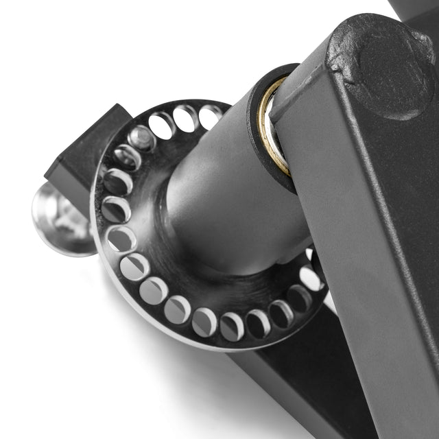 Close-up of the Bells of Steel Shoulder Boulder/Chest Fly Attachment, showing a black metal hinge with a circular, multi-hole component mounted on a tubular structure—ideal for chest fly and similar exercises.