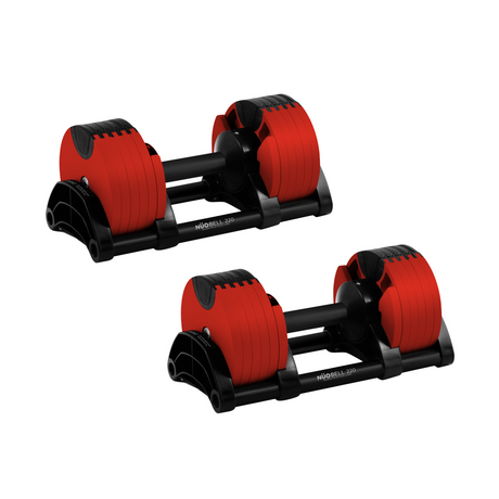 Two adjustable red and black dumbbells with multiple weight plates are placed on black stands against a white background.