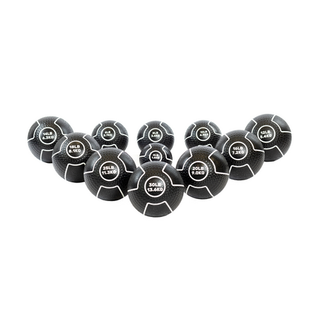 A set of twelve black medicine balls with white markings, each labeled with different weights ranging from 4 LB (1.8 KG) to 30 LB (13.6 KG), arranged in a triangular formation.
