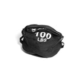 A Bells of Steel Fitness Sandbag, black with handles and "100 LBS" in white on the side, made from durable Condura, is shown on a plain white background.