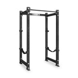 The Bells of Steel Manticore Four Post Power Rack - Prebuilt (3" x 3", 1" Holes), shown in black against a white background, features adjustable holes, safety straps, and a pull-up bar—making it an essential modular addition to any home gym.