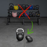 A row of kettlebells is crossed out in red on a rack, while at the front, the Bells of Steel 6-12KG Adjustable Kettlebell and a stack of black weight plates are highlighted with a green arrow—emphasizing versatile training options inspired by Mark Wildman.