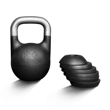 The Bells of Steel Mark Wildman Adjustable Kettlebell, featuring a sleek black body and silver handle designed in the style of Mark Wildman’s competition kettlebells, stands upright alongside a stack of its removable weight plates against a clean white background.