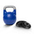 The Bells of Steel Adjustable Competition Kettlebell with a silver handle sits beside four black weight plates on a white background, perfect for kettlebell training.