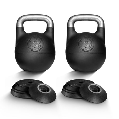 Two black Bells of Steel Adjustable Competition Kettlebells with silver handles stand upright, ideal for kettlebell training. In front, several round weight plates are stacked on a white background.