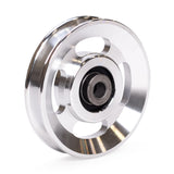 The Bells of Steel Aluminum Pulley Wheels & Upgrade Kits feature a shiny metallic finish, three oval cutouts, and a central bearing—ideal for upgrading your cable machine. Photographed on a clean white background.