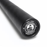 Close-up of the Bells of Steel Powerlifting Bar, featuring "Bells of Steel," "20KG - 29MM," and "Powerlifting Bar" logos. This budget-friendly bar meets IPF specs and stands out against a white background.
