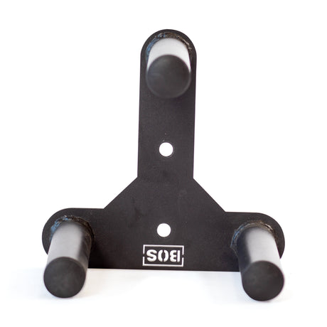 The Bells of Steel Change Plate Storage Pegs is a black metal wall mount rack with three horizontal pegs in a triangular layout for Olympic change plates, two mounting bolt holes, and a white "SIS" logo at the base.