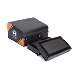 The Bells of Steel Soft Glute Bench is a black and orange rectangular bench with a logo, featuring two removable Velcro padded panels, perfect for glute bridges or hip thrusts.