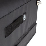 Close-up of a black fabric bag from Bells of Steel, featuring a stitched handle, small circular logo patch, and silver rings. The durable material is ideal for carrying your Soft Glute Bench or hip thrust bench accessories.