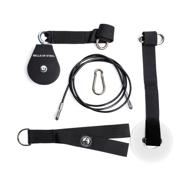 The Bells of Steel Cable Pulley set includes a black pulley, steel carabiner, cable, white loading pin, and black straps with metal rings—ideal for lat pulldowns and tricep pushdowns—displayed on a white background.