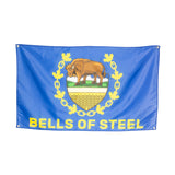 A blue Bells of Steel flag for home gyms, featuring a yellow bison above a shield and maple leaves. "BELLS OF STEEL" is boldly printed in yellow at the bottom—an ideal gym decor piece.