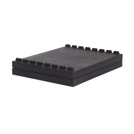 Bells of Steel Stackable Pull Blocks are rectangular black foam pads with evenly spaced square notches in a tongue and groove design, allowing for space-efficient stacking as lifting blocks, shown isolated on a white background.