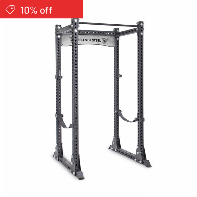 The Manticore Flat Foot Power Rack Builder by Bells of Steel features 3"x3" steel uprights with 1" holes and a prominent "BELLS OF STEEL" logo. Shown in black on a white background, with a red "10% off" label in the top left corner. Ideal for home gyms.