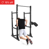 A person in a black shirt and gray shorts performs dips on the Bells of Steel Manticore Half Rack Builder (3" x 3", 1" holes). A “10% off” discount label appears in the top left, set against a clean white background for modern home gyms.