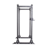 The Manticore Flat Foot Power Rack - Prebuilt by Bells of Steel is a robust black metal structure with adjustable J-hooks, modular parts, and numerous holes for customization. Its 1,000-pound capacity makes it ideal for strength training exercises like squats and bench presses.