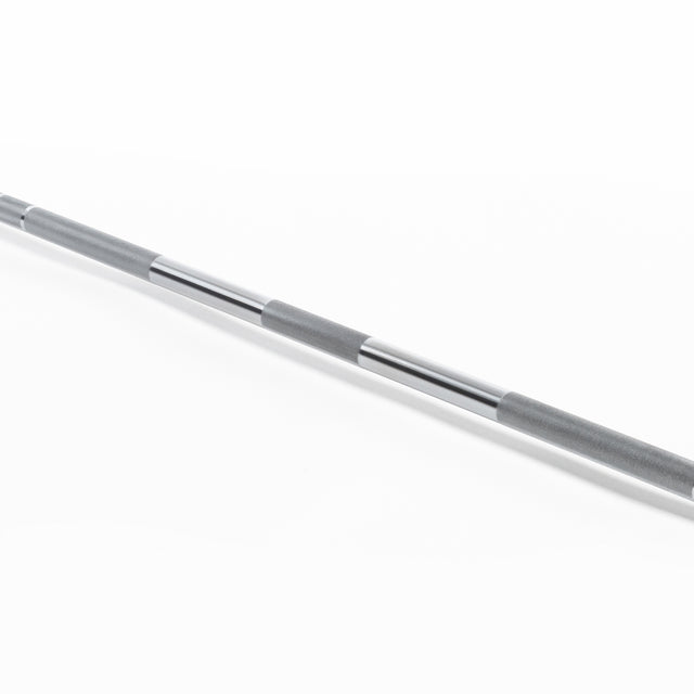 A close-up of the Bells of Steel Olympic Weightlifting Barbell, highlighting its textured grip, smooth chrome finish, and needle bearings, displayed diagonally on a white background.