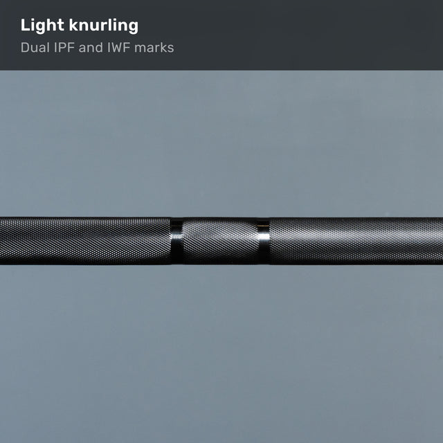 The Bells of Steel Short Rackable Barbell features light knurling and dual IPF/IWF marks, making it an ideal utility bar for any home gym. Shown here in a close-up against a plain grey background.