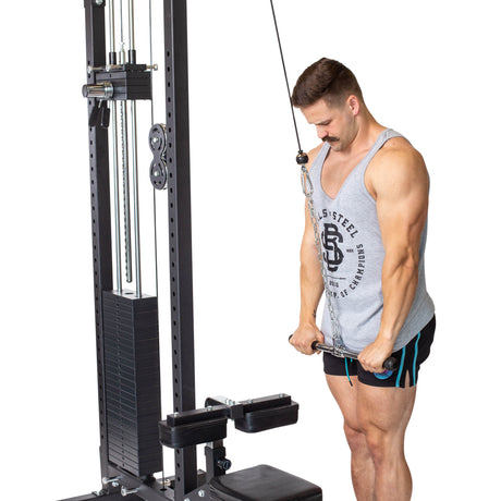 A man in a gray tank top and shorts performs a triceps pushdown on a cable machine using the Bells of Steel Straight Bar Cable Attachment (20"), gripping the bar with both hands while standing upright.