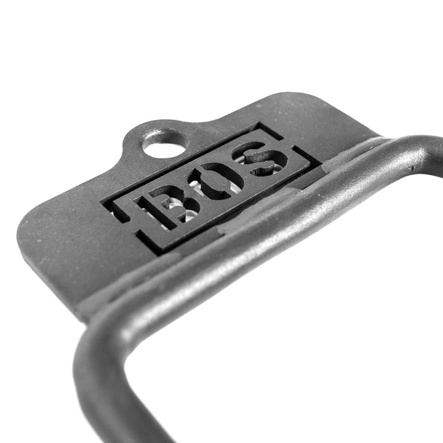 Close-up of the Bells of Steel Fat Bar - Single D Handle, featuring a cut-out "BOS" logo, round top hole, and curved metal bar—ideal for grip strength training. Shown against a white background.