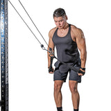 A man in a black tank top and shorts uses the Bells of Steel RocIT Tricep Strap on a cable machine, gripping it with both hands while performing a triceps pushdown against a white background.