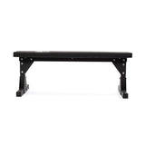 The Bells of Steel Flat Utility Bench features a sturdy padded top and strong metal legs, shown in black from the front against a white background.