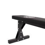 A close-up of the Bells of Steel Flat Utility Bench, featuring a padded seat and a durable metal frame, displayed against a white background.