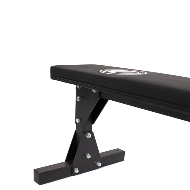 A close-up of the Bells of Steel Flat Utility Bench, featuring a padded seat and a durable metal frame, displayed against a white background.